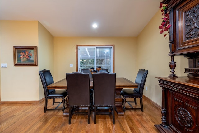 dining space with light hardwood / wood-style flooring