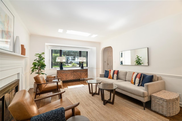 living room featuring crown molding and light hardwood / wood-style flooring