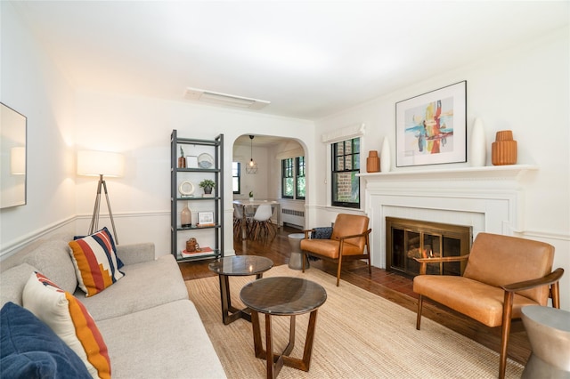 living room featuring radiator heating unit and wood-type flooring