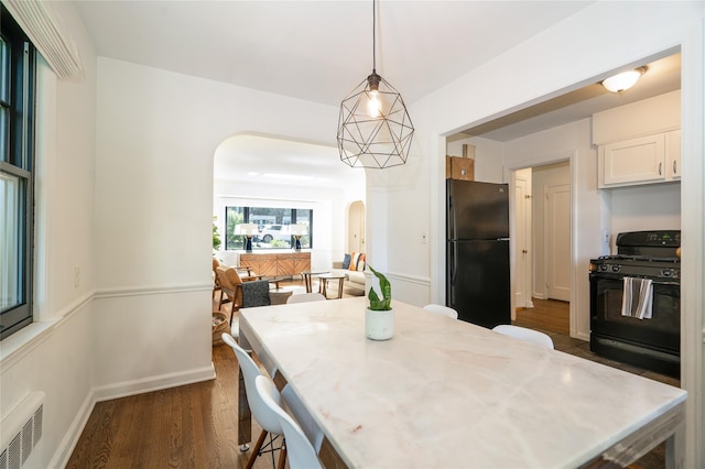 dining room with dark hardwood / wood-style flooring