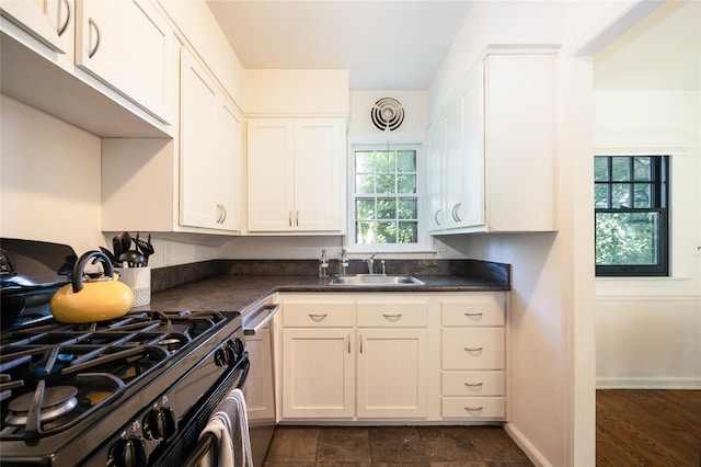 kitchen with white cabinetry, black gas stove, and sink