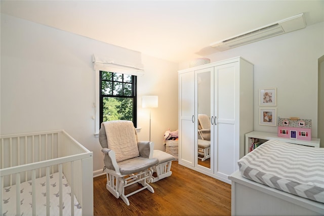 bedroom featuring wood-type flooring and a closet