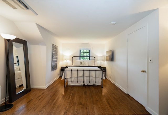 bedroom with dark wood-type flooring