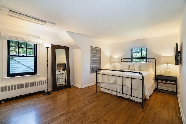 bedroom featuring dark hardwood / wood-style floors and radiator heating unit