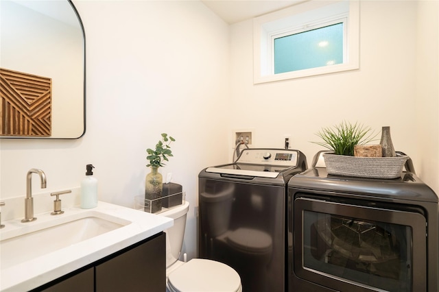 bathroom featuring vanity, toilet, and washing machine and clothes dryer