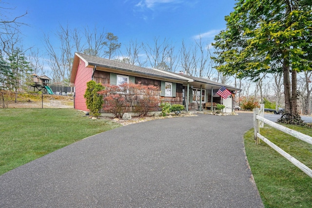 single story home with fence, aphalt driveway, and a front yard