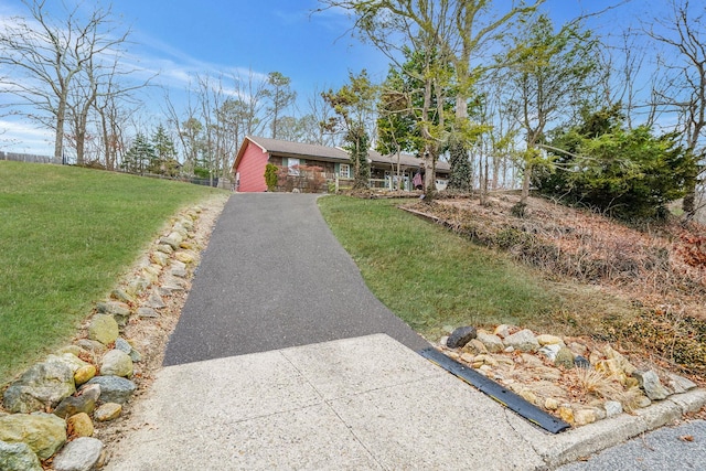 ranch-style home with a front yard and driveway