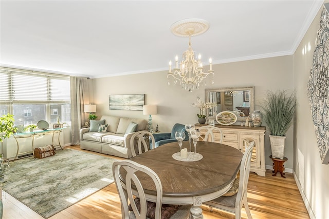 dining space featuring a notable chandelier, crown molding, and light hardwood / wood-style flooring