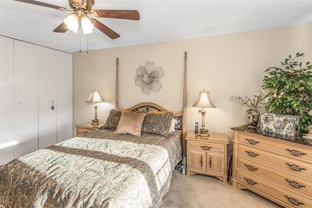 carpeted bedroom with ceiling fan and a closet