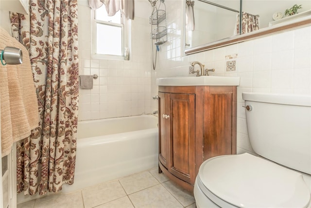 full bathroom with tile walls, tile patterned flooring, vanity, shower / tub combo, and toilet