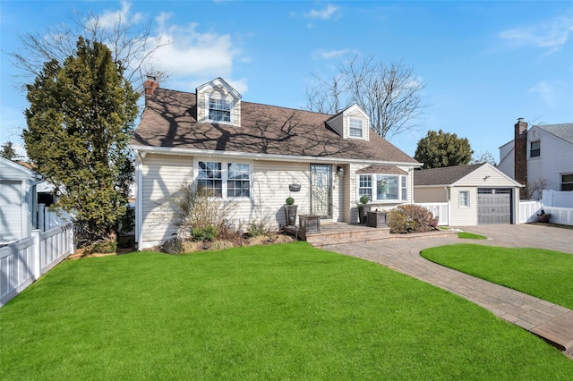 cape cod-style house with a garage, an outdoor structure, and a front lawn