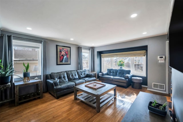 living room featuring hardwood / wood-style floors and ornamental molding