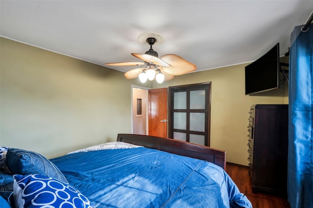 bedroom with ceiling fan and dark hardwood / wood-style flooring