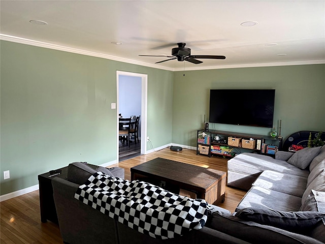 living room featuring wood-type flooring, ornamental molding, and ceiling fan