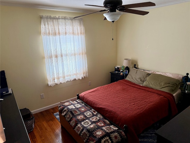 bedroom with ornamental molding, ceiling fan, and dark hardwood / wood-style flooring