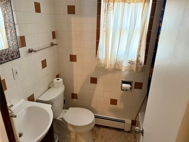 bathroom featuring tile walls, sink, toilet, and baseboard heating