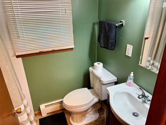 bathroom with a baseboard heating unit, sink, and toilet