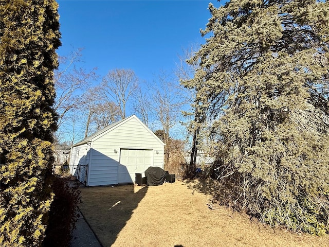 view of property exterior featuring an outbuilding and a garage