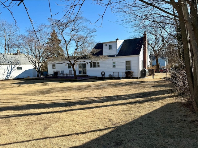 rear view of property featuring a yard