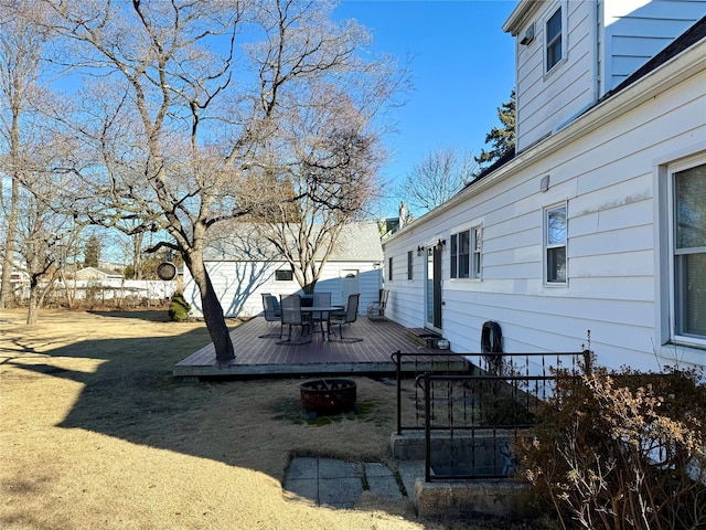 view of yard with a deck and an outdoor fire pit