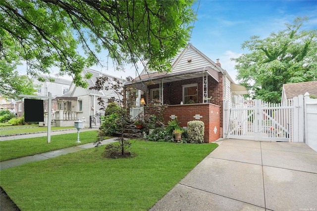 bungalow-style home with a front yard and covered porch