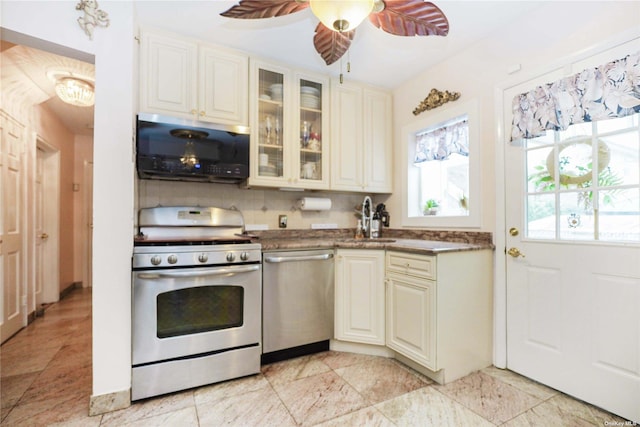 kitchen featuring sink, decorative backsplash, ceiling fan, stainless steel appliances, and cream cabinetry