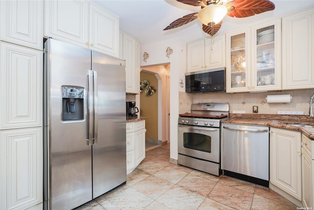 kitchen featuring white cabinetry, appliances with stainless steel finishes, ceiling fan, and decorative backsplash