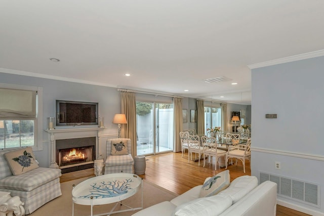 living room featuring ornamental molding and hardwood / wood-style floors