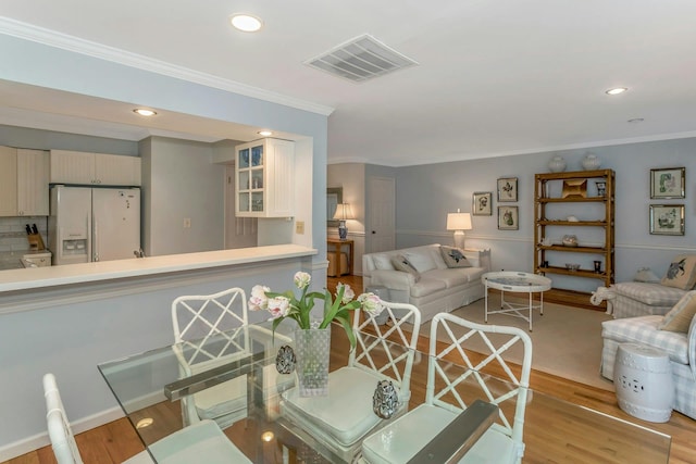 living room featuring ornamental molding and light hardwood / wood-style floors