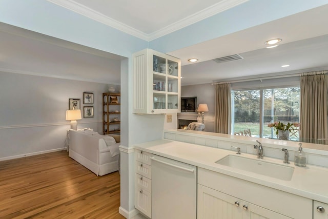 kitchen with white cabinetry, sink, white dishwasher, light hardwood / wood-style floors, and crown molding