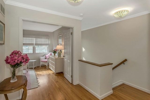 hall featuring ornamental molding and light wood-type flooring