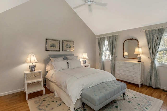 bedroom featuring ceiling fan, high vaulted ceiling, and light hardwood / wood-style floors