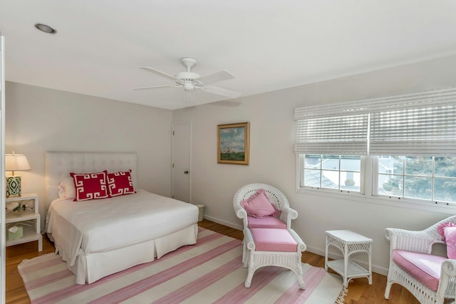 bedroom with light hardwood / wood-style flooring and ceiling fan