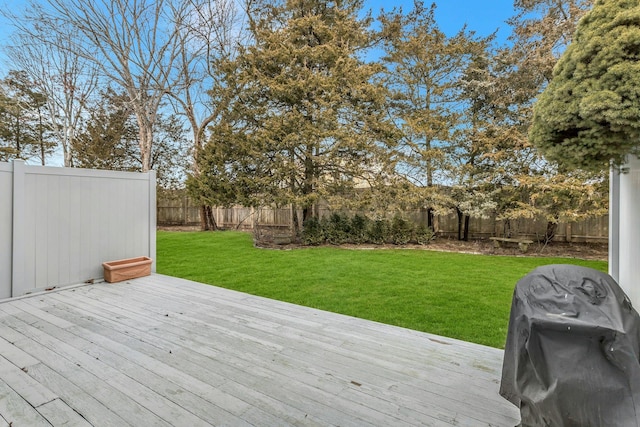 deck featuring grilling area and a lawn