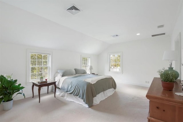 bedroom featuring lofted ceiling and light colored carpet