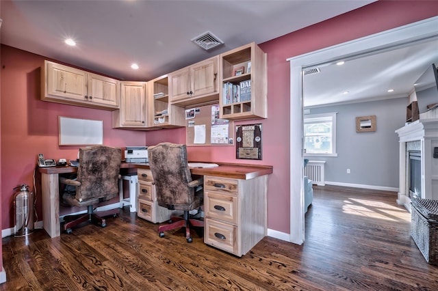 office with radiator heating unit and dark hardwood / wood-style flooring