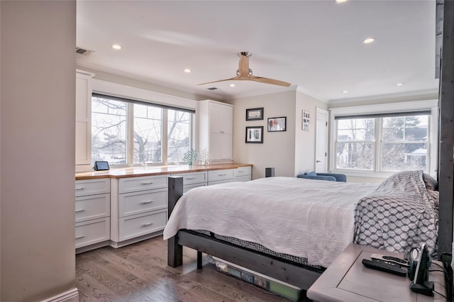 bedroom with ceiling fan, ornamental molding, and light hardwood / wood-style floors