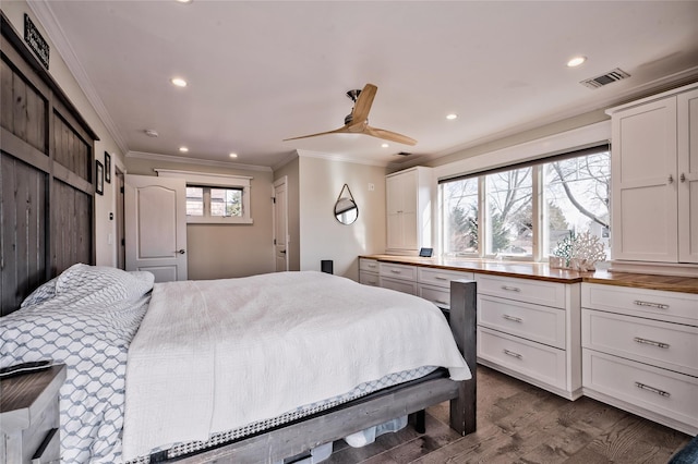 bedroom with dark wood-type flooring, ornamental molding, and ceiling fan