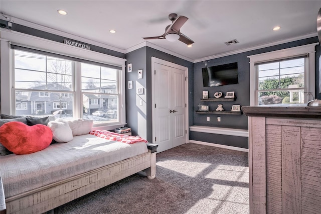 bedroom with ceiling fan, ornamental molding, and carpet