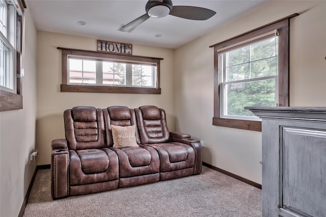 home theater featuring light colored carpet and ceiling fan