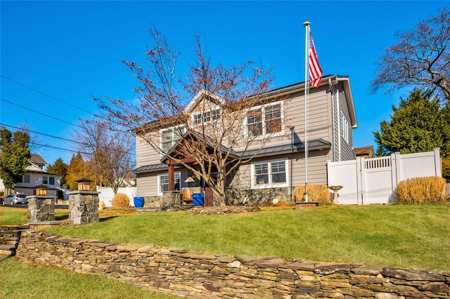 rear view of house featuring a lawn