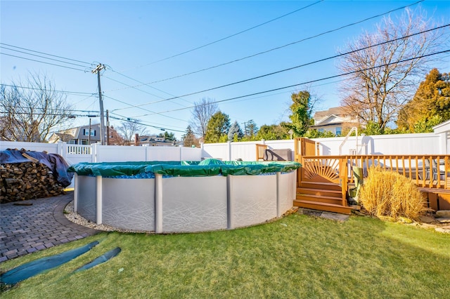 view of yard with a covered pool