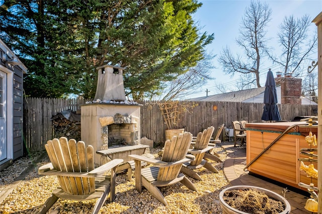 view of patio with an outdoor stone fireplace