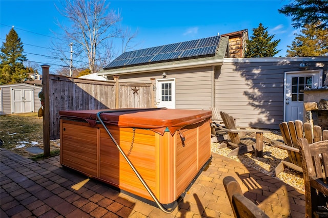 view of outbuilding featuring a hot tub and solar panels