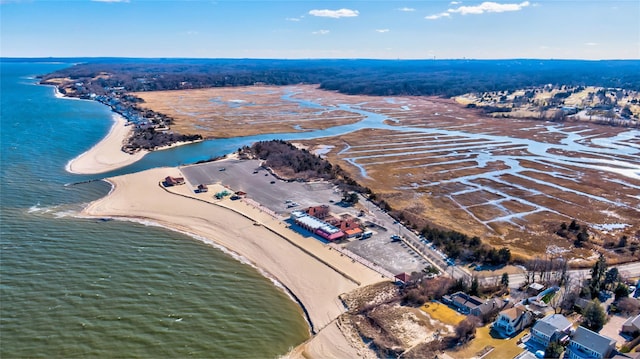 birds eye view of property featuring a water view and a beach view