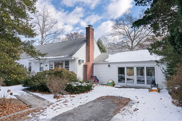 snow covered house featuring french doors