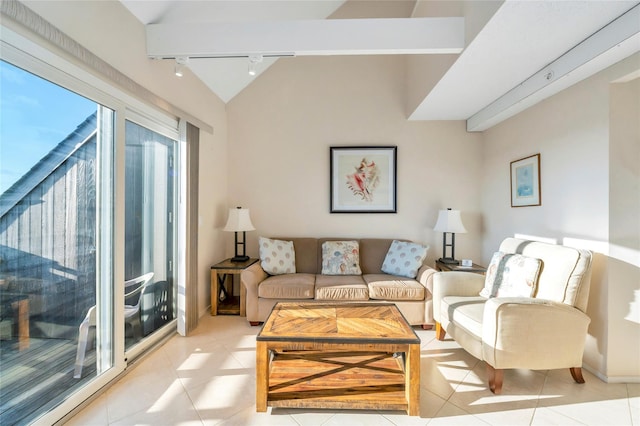 living room with light tile patterned floors, vaulted ceiling, and track lighting