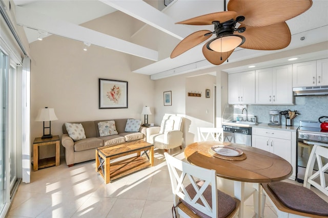 tiled dining space with sink, track lighting, and ceiling fan