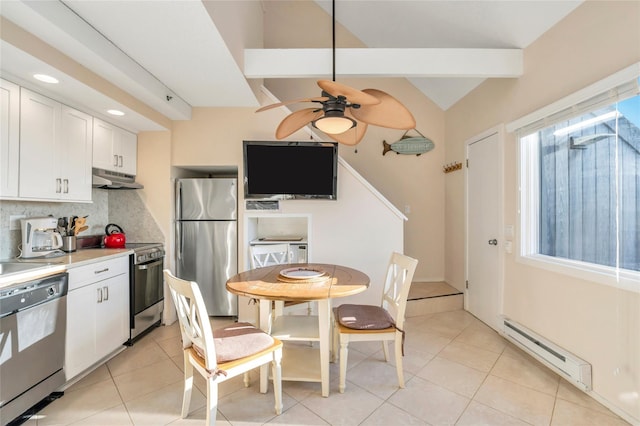 kitchen featuring stainless steel appliances, tasteful backsplash, white cabinets, light tile patterned flooring, and a baseboard radiator