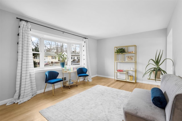 sitting room featuring baseboards and wood finished floors